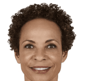 A woman with curly hair is smiling for the camera.