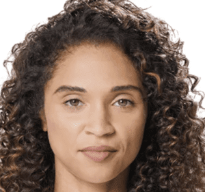 A woman with curly hair and a brown eye.